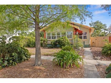 Inviting home exterior with mature trees, green foliage, and sidewalk approach at 3120 8Th N Ave, St Petersburg, FL 33713