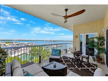 Relax on this beautiful balcony with water views, ceiling fan, and stylish outdoor furniture for ultimate comfort at 425 150Th Ave # 2501, Madeira Beach, FL 33708
