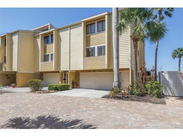 Spacious multi-level townhouse featuring a two-car garage and private entrance at 472 Sandy Hook Rd, Treasure Island, FL 33706