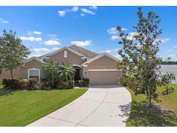Charming single-story home featuring a well-manicured lawn, mature landscaping, and a two-car garage at 626 15Th Nw Ave, Ruskin, FL 33570