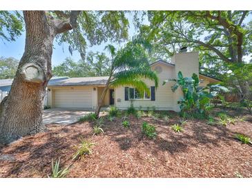 Charming single-story home with mature landscaping and inviting curb appeal at 940 Woodland Dr, Palm Harbor, FL 34683