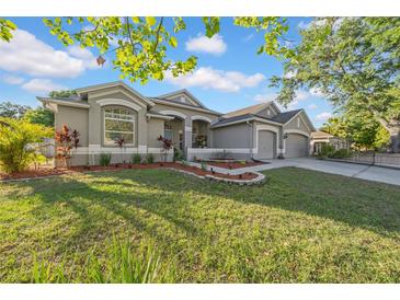 Charming single-story home with manicured lawn and tasteful landscaping, showcasing curb appeal at 4010 Lithia Ridge Blvd, Valrico, FL 33596