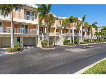 Attractive townhome exterior showcasing well-maintained landscaping and convenient parking access at 456 Bahia Beach Blvd, Ruskin, FL 33570