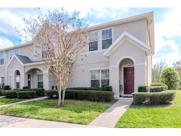Inviting townhome exterior with manicured lawn and fresh landscaping at 15939 Fishhawk View Dr, Lithia, FL 33547