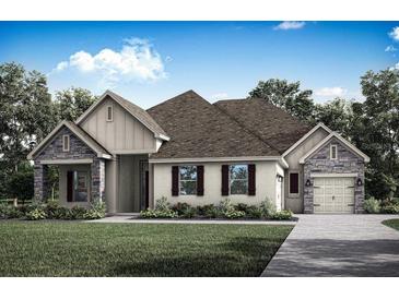 Charming single-story home featuring stone accents, a gabled roof, and a two-car garage at 17444 Nokota Ave, Hudson, FL 34667