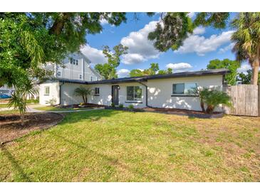 Charming single-story home boasts a beautifully landscaped front yard and freshly painted exterior at 321 Shore E Dr, Oldsmar, FL 34677