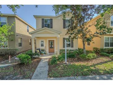 Charming two-story home featuring a welcoming front porch and well-maintained landscaping at 9205 English Oaks Ln, Riverview, FL 33578