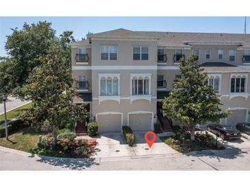 Beautiful three-story townhome featuring an attached two-car garage and well-manicured landscaping at 1105 Venetian Harbor Ne Dr, St Petersburg, FL 33702