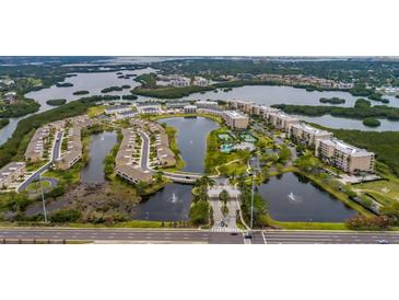 Beautiful aerial view of the Seminole Isle community featuring lakes, ponds, lush greenery, and well-maintained buildings at 7040 Key Haven Rd # 601, Seminole, FL 33777