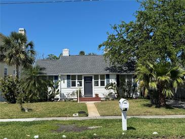Charming single-story home with a well-maintained lawn and lush, mature landscaping at 766 Bay Esplanade, Clearwater Beach, FL 33767