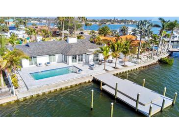 Waterfront home with modern pool, dock, and outdoor seating overlooking beautiful bay waters at 1493 Sea Gull S Dr, St Petersburg, FL 33707