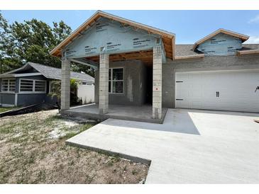 New construction home with a concrete driveway and covered porch at 1828 27Th N Ave, St Petersburg, FL 33713