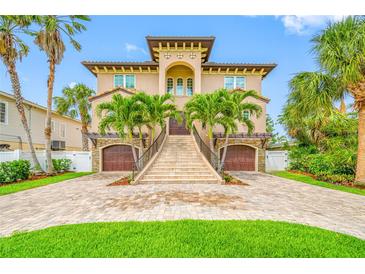 Stunning two-story home with lush landscaping, grand staircase entry, and twin garages at 2149 Bayou Grande Ne Blvd, St Petersburg, FL 33703