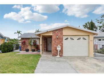 Charming single-Gathering home with a brick facade, well-maintained lawn, and attached garage at 4902 Blue Heron Dr, New Port Richey, FL 34652