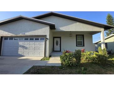 Charming single-story home featuring an attached garage, covered entry, and beautifully landscaped front yard at 5180 69Th N Ave, Pinellas Park, FL 33781