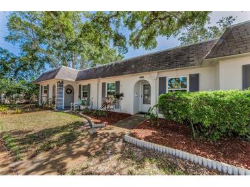 Charming single-story home featuring a well-maintained lawn, mulch beds, and decorative shutters enhancing curb appeal at 4252 Sheldon Pl # 4252, New Port Richey, FL 34652
