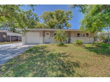 Charming single-story home with a well-maintained lawn, brick accents, and a one-car garage at 1710 S Lake Ave, Clearwater, FL 33756
