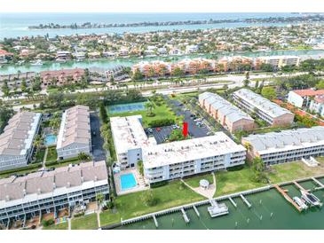 Expansive aerial view of waterfront condos with a pool, tennis court and Gulf views at 719 Pinellas Bayway S # 309, St Petersburg, FL 33715