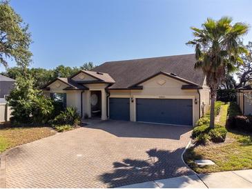 Charming single-story home featuring a two-car garage, paved driveway, and mature landscaping at 10404 Scarlet Chase Dr, Riverview, FL 33569
