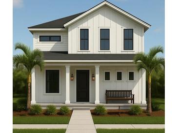 Charming two-story home featuring a classic white exterior with black trim, front porch, and tropical landscaping at 1200 13Th N St, St Petersburg, FL 33705