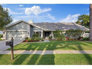 Charming single-story home featuring a landscaped front yard and attached two-car garage at 2969 Talon Dr, Clearwater, FL 33761