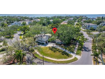 Aerial shot pinpointing a lovely home nestled among lush trees, surrounded by a well-maintained neighborhood at 5001 W Dickens Ave, Tampa, FL 33629