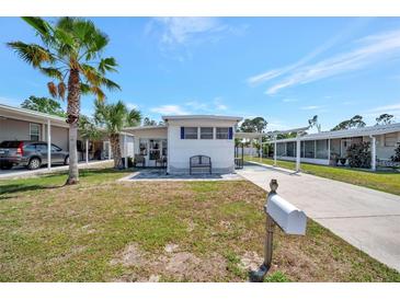 Charming single-story home with a well-manicured lawn and a covered carport, perfect for easy parking at 264 S Port Royal Ln, Apollo Beach, FL 33572
