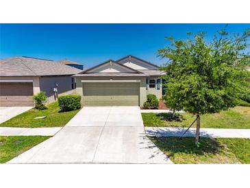 Charming single-story home with a well-manicured lawn, two car garage, and welcoming curb appeal at 7236 Salt River Ave, Sun City Center, FL 33573