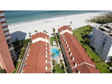 An aerial view of the condo complex showing a swimming pool and proximity to the beach at 17960 Gulf Blvd # 104, Redington Shores, FL 33708
