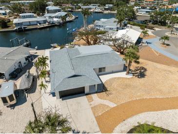 Waterfront home with attached garage, landscaping, and close proximity to a canal at 9920 Spoonbill E Rd, Bradenton, FL 34209