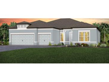 Charming single-story home with a three-car garage, manicured lawn, and tasteful landscaping at 11432 Shoreline Trl, Parrish, FL 34219