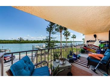Cozy balcony featuring views of the water and docks, perfect for relaxing and enjoying the waterfront scenery at 18201 Gulf Blvd # 201, Redington Shores, FL 33708