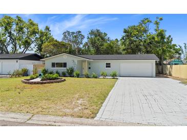 Charming single-story home with a well-manicured lawn, paved driveway, and lovely landscaping at 2274 66Th S Ave, St Petersburg, FL 33712