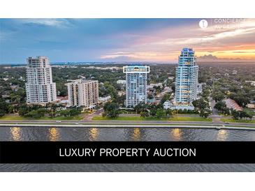 Stunning aerial view of a luxury condo building near the water at sunset at 3435 Bayshore Blvd # 2100P, Tampa, FL 33629