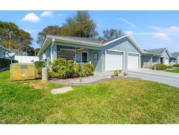 Charming single-story home with a well-maintained lawn and attached two-car garage at 6745 Basswood Cir, Zephyrhills, FL 33542
