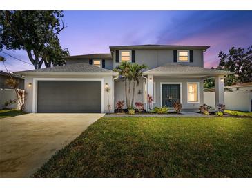 Charming two-story home boasts a well-manicured lawn and a spacious two-car garage at 3612 W Pearl Ave, Tampa, FL 33611