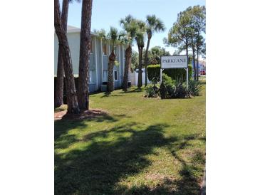 Parklane Condominiums sign surrounded by palm trees and lush green grass at 379 47Th N Ave # 104, St Petersburg, FL 33703