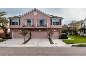 Charming townhome with two stories, garage, balconies, and manicured landscaping at 584 52Nd N Ave, St Petersburg, FL 33703