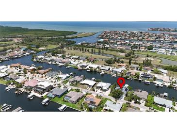 Waterfront property with canal access, lush landscaping, boat dock and quick access to Tampa Bay at 907 Golf Island Dr, Apollo Beach, FL 33572