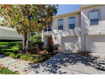 Charming two-story townhouse with well-maintained landscaping and attached one car garage at 9814 Ashburn Lake Dr, Tampa, FL 33610