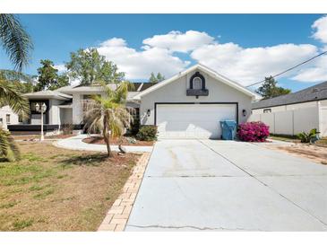 Charming single-Gathering home with a two-car garage and a well-maintained front yard at 10021 Elgin Blvd, Spring Hill, FL 34608