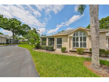 Charming single-story home with lush landscaping and large windows at 1211 Golfview Woods Dr, Sun City Center, FL 33573