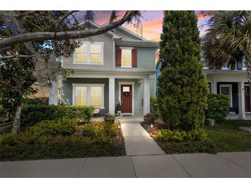 Charming two-story home with well-manicured landscaping and a welcoming front porch at 14493 Promenade Pkwy, Odessa, FL 33556
