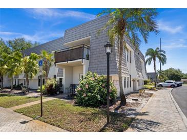 Charming two-story condo with a beautiful lawn, mature landscaping, and a second story balcony at 716 Lyndhurst St # 702, Dunedin, FL 34698