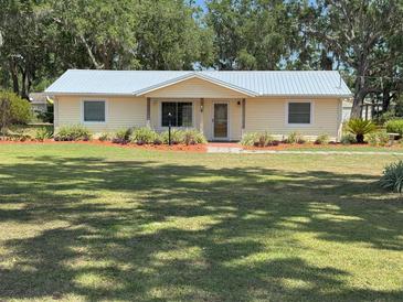 Charming single-story home featuring a well-maintained lawn and colorful landscaped flower beds at 1504 Swilley Rd, Plant City, FL 33567