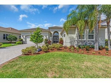 Charming home with a lush lawn, well-manicured landscaping, and a welcoming front entrance at 2165 Hollow Forest Ct, Wesley Chapel, FL 33543