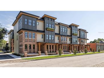 Beautiful modern townhomes feature brick facade and covered entryways at 409 E Oak Ave # 9, Tampa, FL 33602