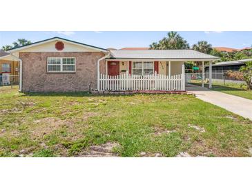 Charming single-Gathering home with a stone facade and a well-maintained front yard with white picket fence at 6556 S West Shore Cir, Tampa, FL 33616