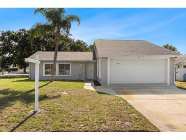 Charming single-story home with a well-maintained lawn and attached two-car garage at 1985 Hastings Dr, Clearwater, FL 33763
