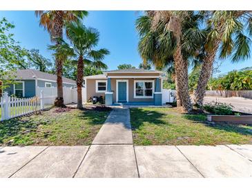 Charming single-story home featuring palm trees and a well-maintained front yard at 212 28Th S St, St Petersburg, FL 33712
